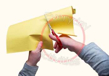 Stock Photo Child Cutting Yellow Construction Paper With Scissors